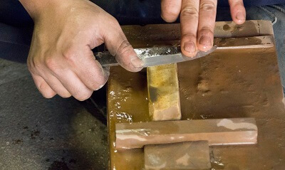 finishing up sharpening knife with waterstone