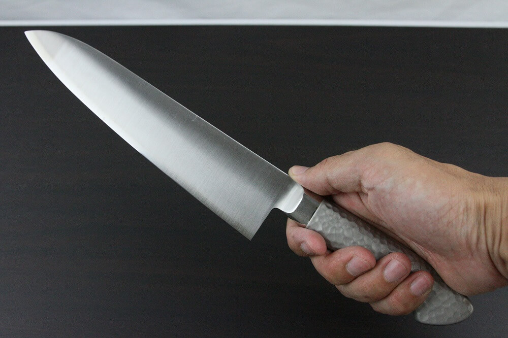 elemon_gyuto210_08 Japanese Chef Knife, Elegance Monaka Series, Gyuto chef knife 210mm, grabbed by a man's hand