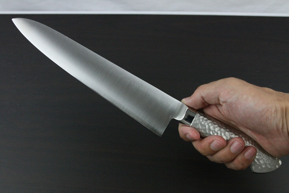 elemon_gyuto240_08 Japanese Chef Knife, Elegance Monaka Series, Gyuto chef knife 240mm, grabbed by a man's hand