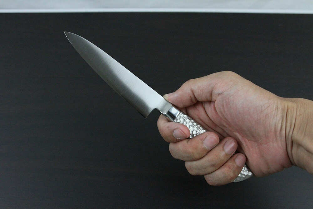 elemon_petit120_08 Japanese Chef Knife, Elegance Monaka Series, petit knife 120mm, grabbed by a man's hand