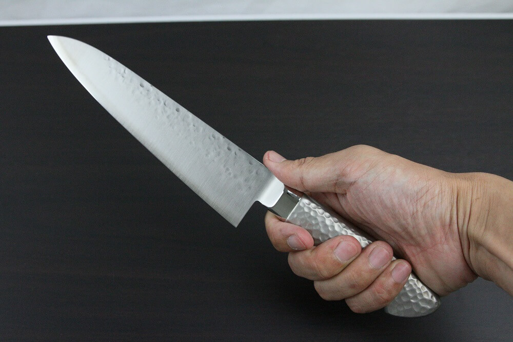hamfin_gyuto180_08 Japanese Chef Knife, Hammer Finish Series, Gyuto chef knife 180mm, grabbed by a man's hand