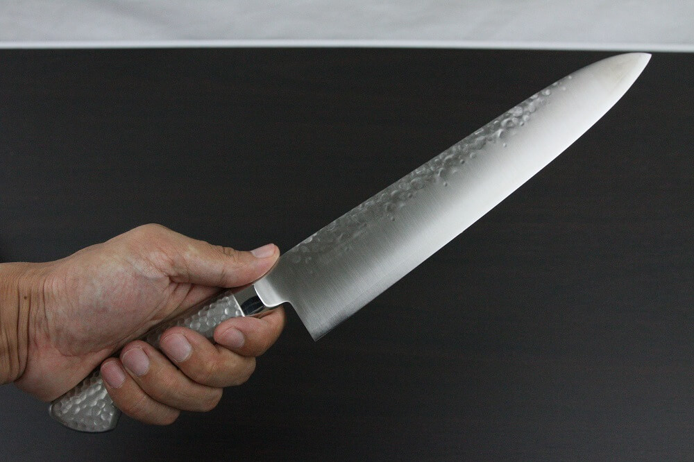 hamfin_gyuto240L_08 Japanese Chef Knife, Hammer Finish Series, Gyuto chef knife 240mm left-handed, grabbed by a man's hand