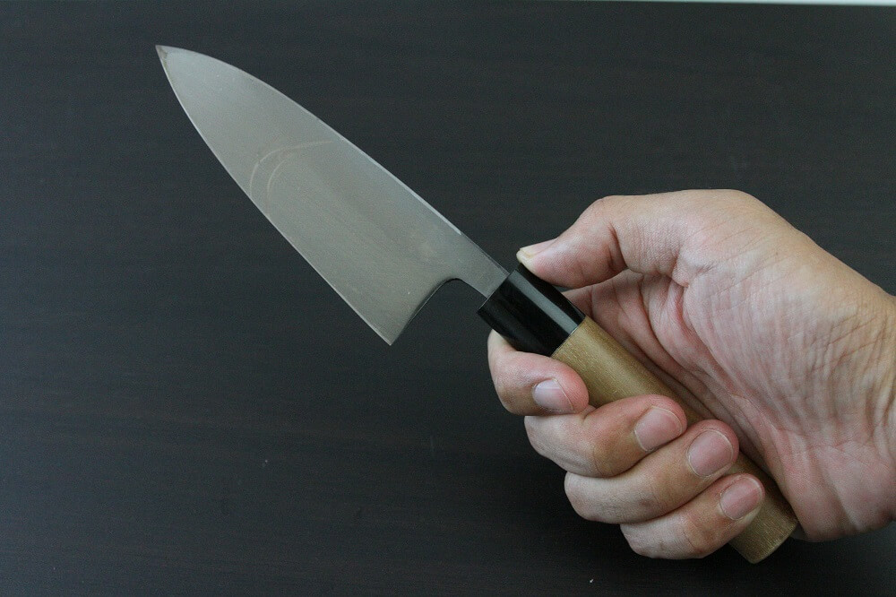 1st_deba_120_IMG_6553 Japanese professional chef knife, Deba fillet knife, steel 120mm, grabbed by a man's hand