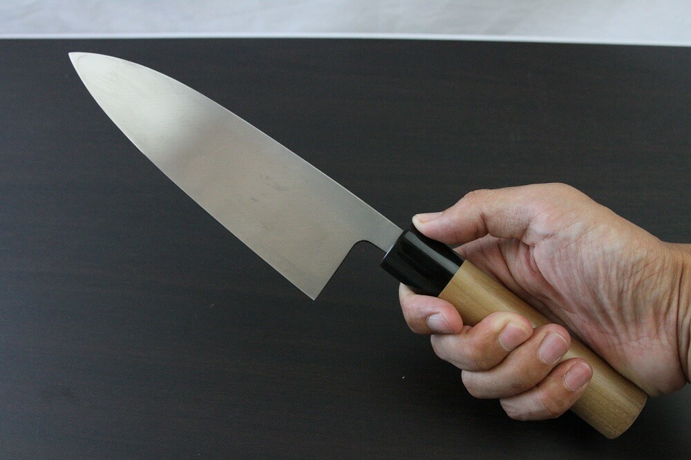 1st_deba_180_IMG_6555 Japanese professional chef knife, Deba fillet knife, steel 180mm, grabbed by a man's hand